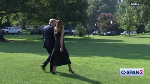 Donald and Melania Trump then walk together to board Marine One.