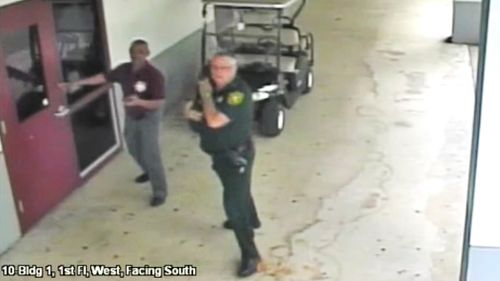Scot Peterson, right, outside Marjory Stoneman Douglas High School in Parkland, Florida on March 15. Picture: AP