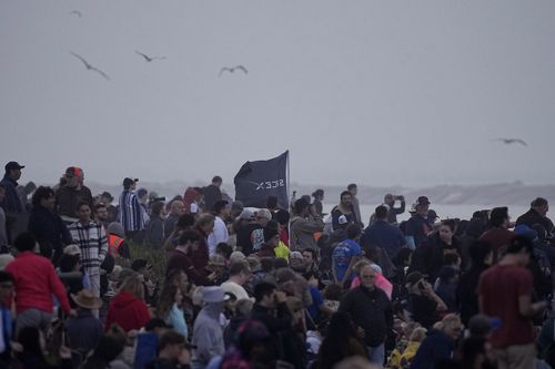 People gather to watch SpaceX's mega rocket Starship launch it's third test flight from Starbase in Boca Chica, Texas, Thursday, March 14, 2024