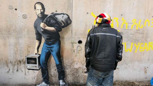 Banksy’s artwork of Steve Jobs in Calais ‘Jungle’ refugee camp highlights benefits of migration 