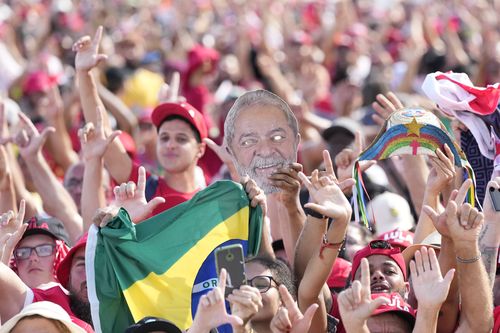 Supporters wait for Luiz Inacio Lula da Silva to arrive on an open car to the Planalto Palace after he was sworn in as new president in Brasilia, Brazil, Sunday, Jan. 1, 2023. (AP Photo/Andre Penner)