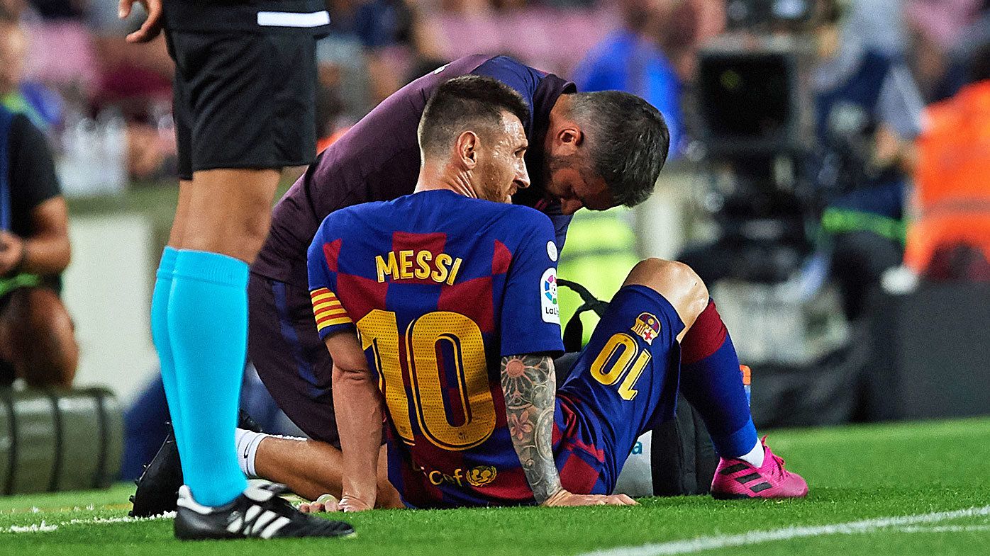Lionel Messi of FC Barcelona receives medical treatment 