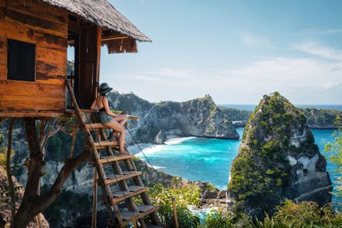 Bali, Indonesia, traveler on tree house at Diamond Beach in Nusa Penida Island.