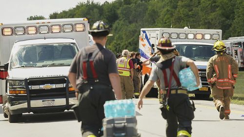Rescue personnel work the scene of a tour bus that crashed and rolled over on the New York State Thruway near Pembroke, N.Y., Friday, Aug. 22, 2025. (Libby March/The Buffalo News via AP)