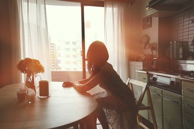 Sad woman in kitchen getty