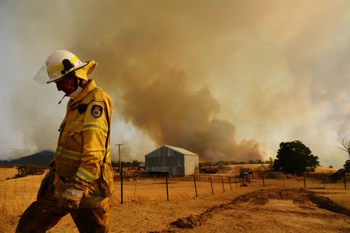 TUMURUMBA, AUSTRALIA - JANUARY 11: A Rural Fire Service firefighter Trevor Stewart views a flank of a fire on January 11, 2020 in Tumburumba, Australia. Cooler temperatures forecast for the next seven days will bring some reprieve to firefighters in NSW following weeks of emergency level bushfires across the state, with crews to use the more favourable conditions to contain fires currently burning. 20 people have died in the bushfires across Australia in recent weeks, including three volunteer f