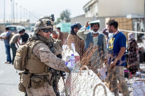 Marines with Special Purpose Marine Air-Ground Task Force-Crisis Response-Central Command provide assistance during an evacuation at Hamid Karzai International Airport in Kabul.