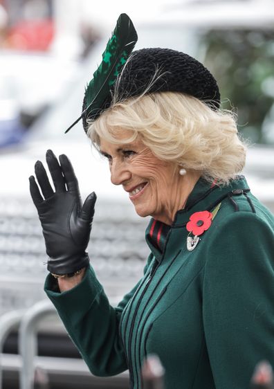 Camilla, Queen Consort  waves and smiles as she attends the 94th Year of The Field Of Remembrance at Westminster Abbey on November 10, 2022 in London 