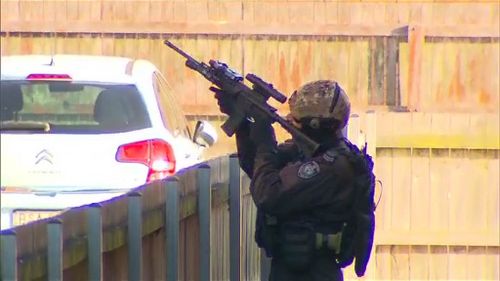 Heavily-armed police have raided an apartment in Sydney's southwest that turned out to be empty. (9NEWS)