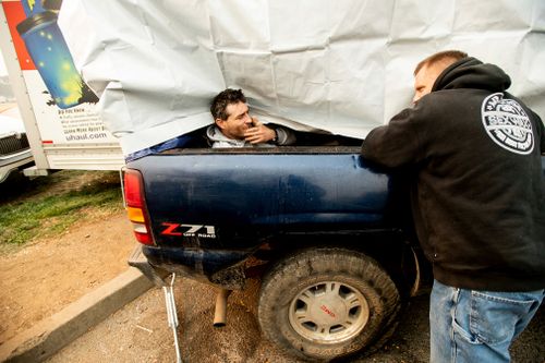 Eric Bass, left, and Troy Bledsoe, evacuees of the Camp Fire, spend time at a makeshift shelter.