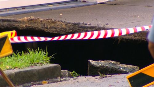 A firefighter was lowered into the sinkhole. (9NEWS)