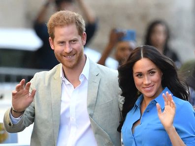 Prince Harry and Meghan Markle waving to crowd at public event