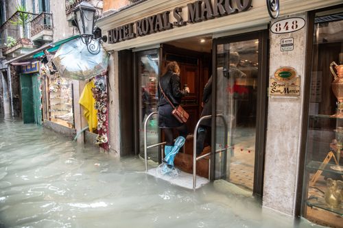 A tourist takes refuge from the sunken streets in a hotel.