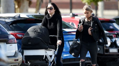 Danielle Stephens (left), the daughter of Roberta Williams, arrives at the funeral at Saint Therese's Parish earlier today. (AAP)