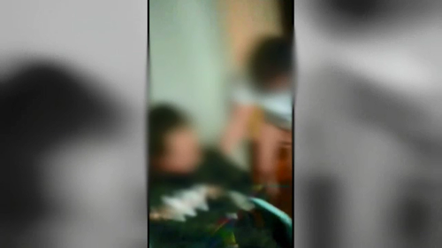 Video has emerged depicting a woman tied to a chair.