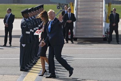 US President Donald Trump tries to hold wife Melania's hand 