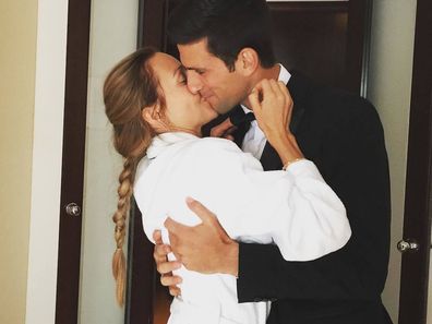 Novak and Jelena Djokovic share a kiss.