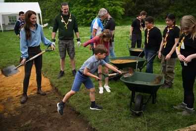 Prince Louis of Wales helps his mother, Catherine, Princess of Wales, take part in the Big Help Out, during a visit to the 3rd Upton Scouts Hut in Slough on May 8, 2023 