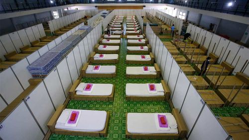 Thai workers prepare a field hospital for COVID-19 patients in Bangkok, Thailand.