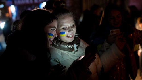 Ukrainians gather in central Kyiv to celebrate the recapturing of Kherson.