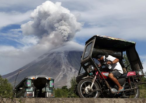 A Filipino villager looks on as Mayon Volcano erupts anew in Legaspi city, Albay province, Philippines in January 2018. 