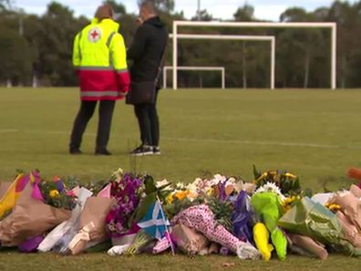 Flowers at the park where Eurydice was allegedly raped and murdered last week. (9News)