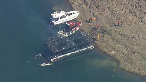 The houseboat is destroyed and a nearby speed boast was also damaged. (9NEWS)