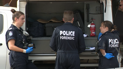Police outside the scene yesterday after the body was discovered.