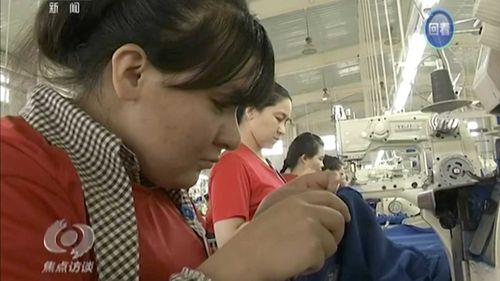 Muslim trainees work in a garment factory