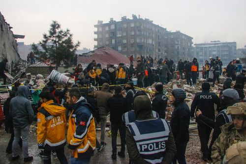 People and rescue teams try to reach trapped residents inside collapsed buildings in Diyarbakir, Turkey, Monday, Feb. 6, 2023.  