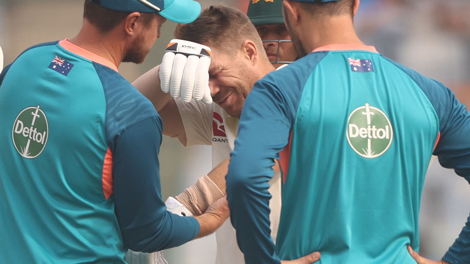 David Warner of Australia has his elbow looked at by medical staff after he was struck by a ball from Mohammed Siraj of India during day one of the Second Test match in the series between India and Australia at Arun Jaitley Stadium on February 17, 2023 in Delhi, India. (Photo by Robert Cianflone/Getty Images)