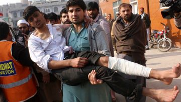 The Taliban has launched the deadliest terrorist attack in Pakistan's history, killing more than 100 children. <br><br>A man carries an injured victim of a massive Taliban attack on a school in the northwestern Pakistani city of Peshawar. (Getty Images)