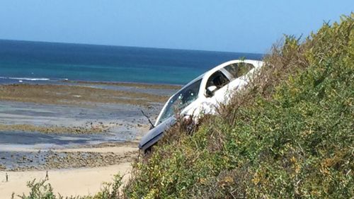 Emergency services were forced to climb down the cliff and pull the driver to safety. (Supplied, Emma Bowles)