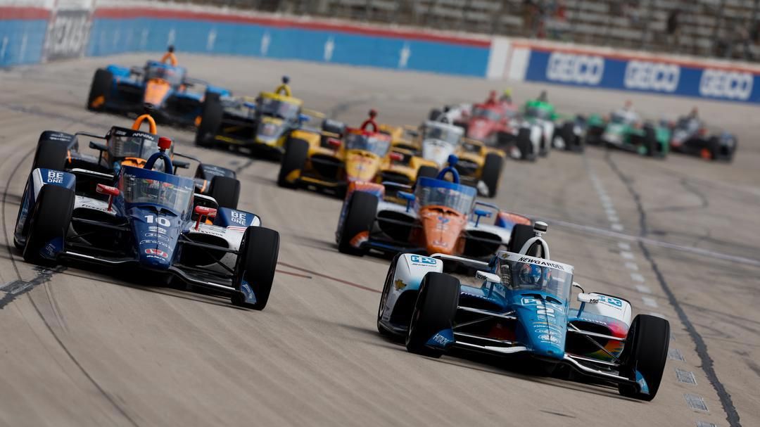 Josef Newgarden leads a pack of cars running side-by-side at Texas Motor Speedway.