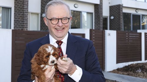 Prime Minister Anthony Albanese with homeowner Abbey Woods and her dog Chilli, after a visit to their home in the Canberra suburb of Lawson, on Monday 25 August 2025. 