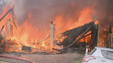 A monster fire that tore through three homes in Brisbane has left three people in hospital, including two firefighters.