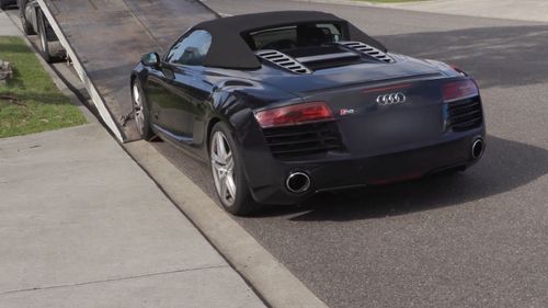 Police seize an Audi R8 as part of raids across the North West