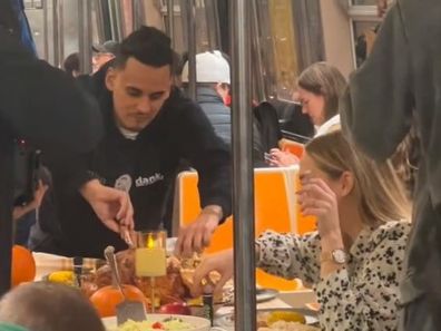 Group of friends having Thanksgiving dinner on the subway