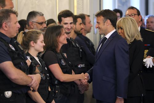 French President Emmanuel Macron and his wife Brigitte Macron, right, meet rescue forces, in Annecy, French Alps, Friday, June 9, 2023.  