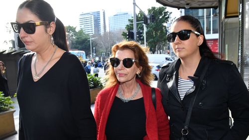 Rosa Miano (centre), wife of John Jarratt, arrives at the Downing Centre Local Court in Sydney.