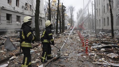 Firefighters extinguish a building of Ukrainian Security Service (SBU) after a rocket attack in Kharkiv, Ukraine's second-largest city, Ukraine, Wednesday, March 2, 2022.