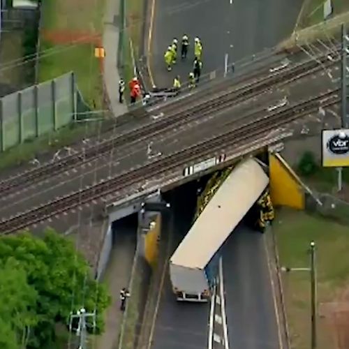 New footage shows truck topple and get jammed under Brisbane bridge