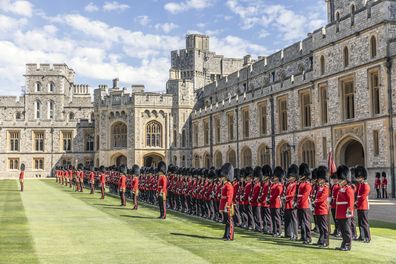 The 1st battalion Irish guards line up on parade in the Quadrangle of Windsor Castle where their new colours were presented to the regiment by Britain's Prince William, Colonel of the Irish Guards, in Windsor, England, Tuesday, May 17, 2022. 