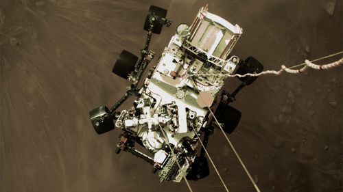 The Perseverance rover lowered towards the surface of Mars.