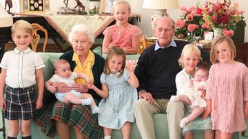The Queen and Prince Philip surrounded by seven of their great-grandchildren at Balmoral Castle in 2018 (L-R front: Prince George, Queen with Prince Louis, Princess Charlotte, Prince Philip, Isla Phillips, Lena Tindall, Mia Tindall. Back: Savannah Phillips)