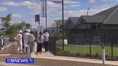 A family gathered at the Kialla display home this afternoon.