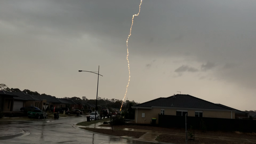 The car escaped visible damage despite being struck by the impressive lightning bolt.