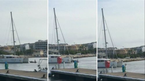 Footage showed one man washed underneath a catamaran.