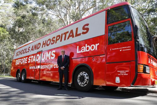 Luke Foley poses in front of the Schools and Hospitals Before Stadiums bus at a press conference announcing the start of a week-long bus tour around the state in March. Picture: AAP