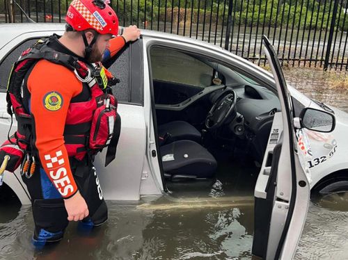 An SES car stuck in knee-deep floods in Clyde, Sydney.